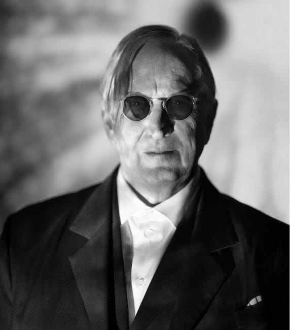 black and white portrait of T Bone Burnett in round sunglasses