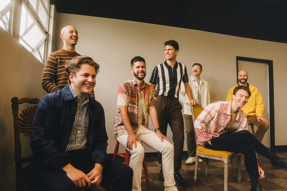 The seven members of The Dip in a room