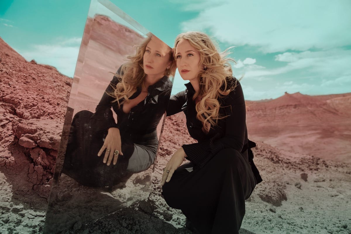 MARGO PRICE leans against a mirror, photographed in Ebntonite Hills, Utah 2022