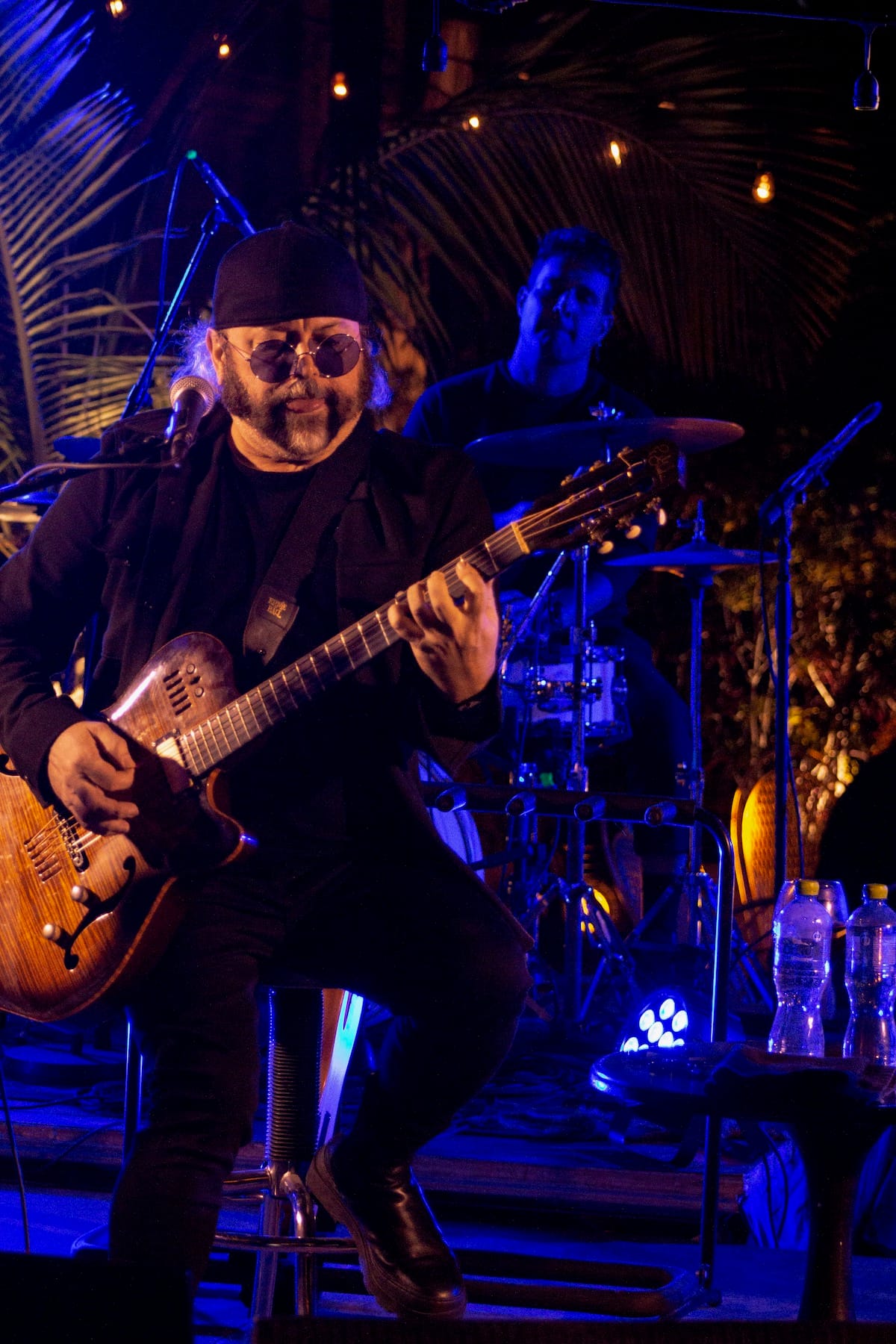 Carlos Varela performs onstage with electric guitar