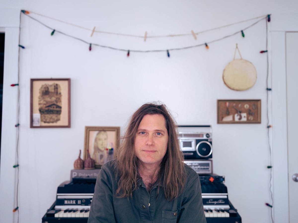 Eric D. Johnson sitting in front of his stereo