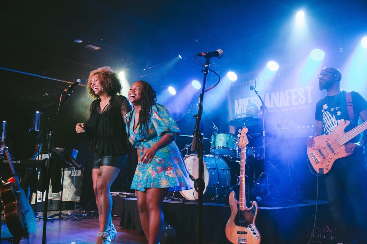 Rissi Palmer and Miko Marks onstage bathed in blue light