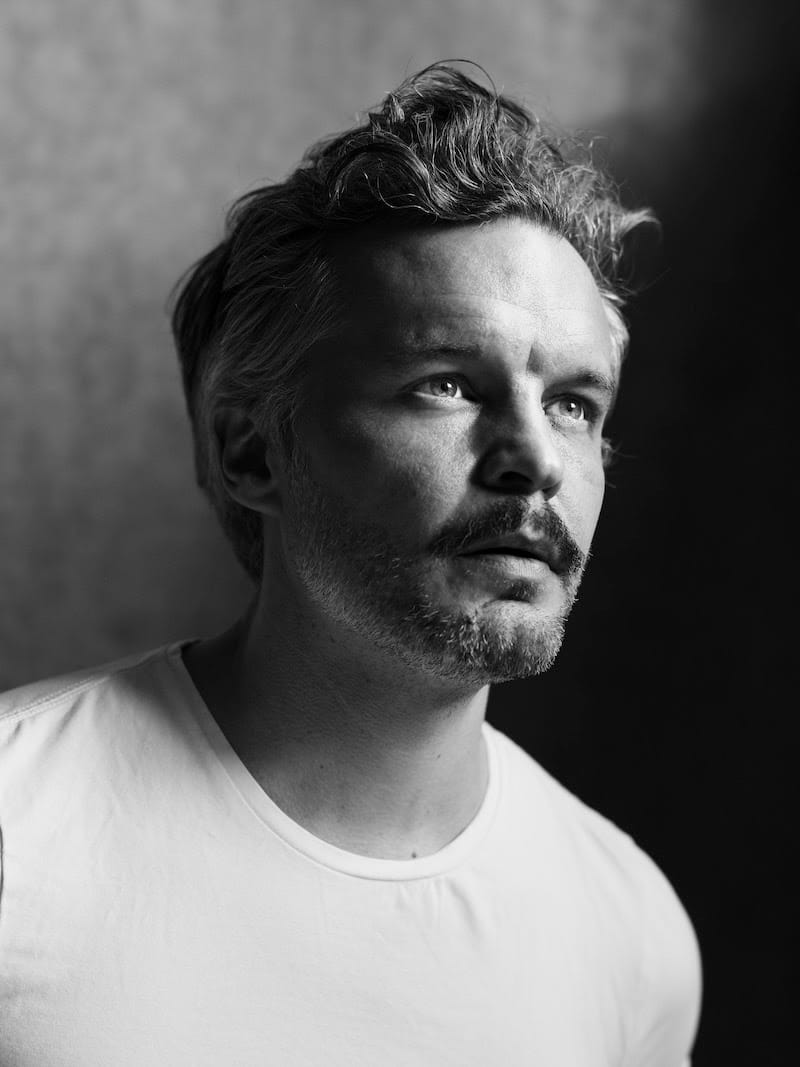 Black and white portrait of Kristian Matsson looking upward